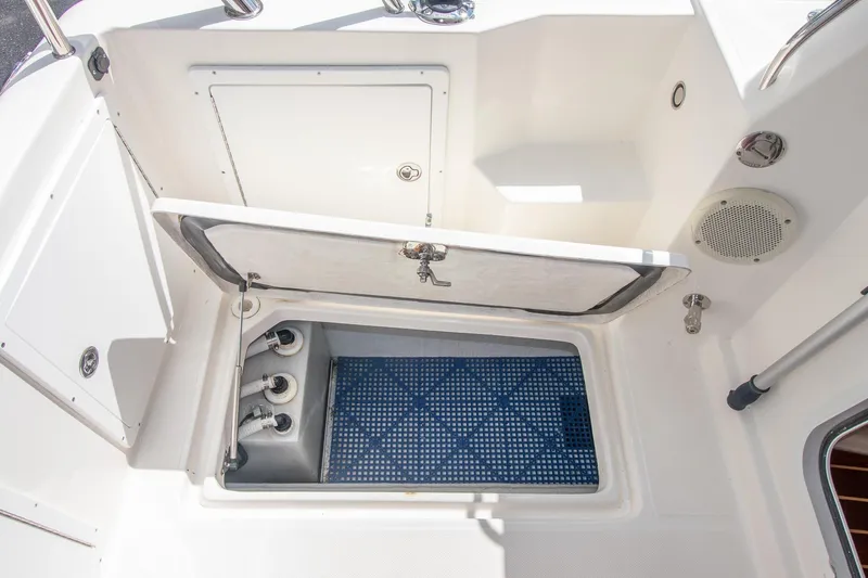 R Time Yacht Photos Pics 2013 Aspen C90 boat storage compartment with open hatch and visible plumbing.