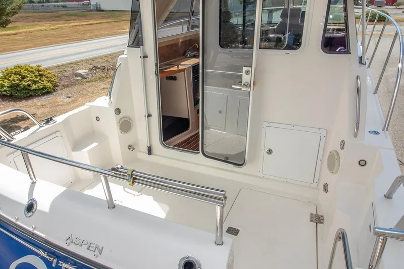 R Time Yacht Photos Pics 2013 Aspen C90 boat stern view with open cabin door and railing.