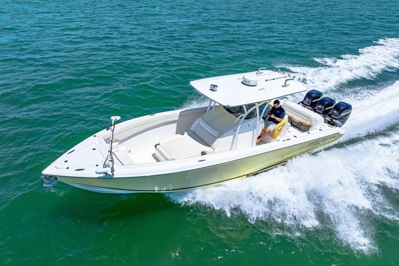 Yacht Photos Pics 2013 Nor-Tech 340 SS boat cruising on open water, featuring triple outboard engines.