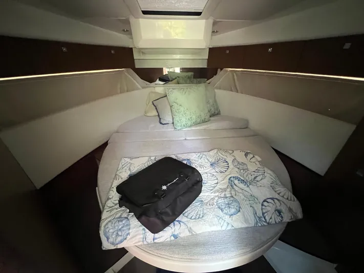  Yacht Photos Pics Interior cabin of 2023 Jeanneau 1095 NC with cozy bedding and cushions.