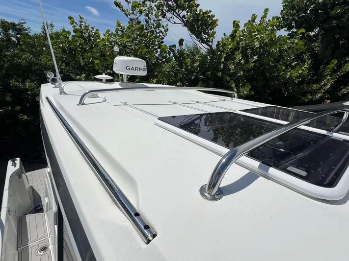  Yacht Photos Pics 2023 Jeanneau 1095 NC boat roof with Garmin radar and sleek design.