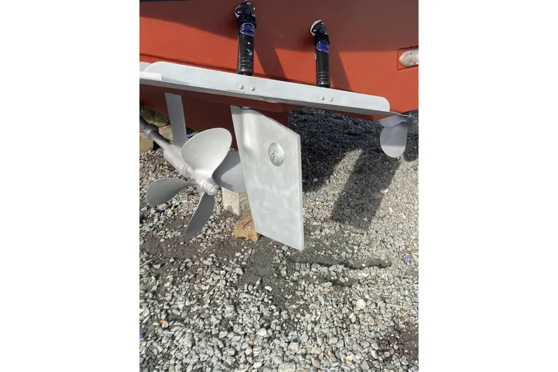 Escapade Yacht Photos Pics Propeller and rudder of 1999 Legacy Yachts 40 Sedan on gravel surface.