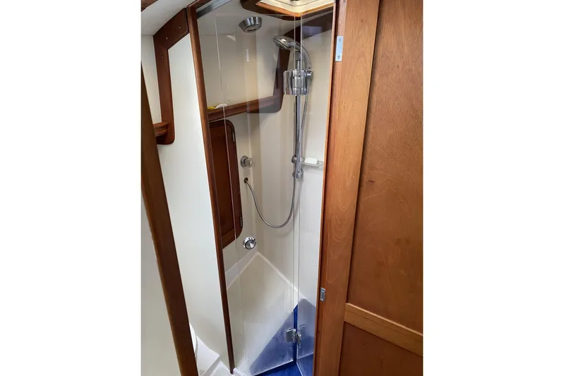 Escapade Yacht Photos Pics Shower area in 1999 Legacy Yachts 40 Sedan, featuring wooden accents and modern fixtures.