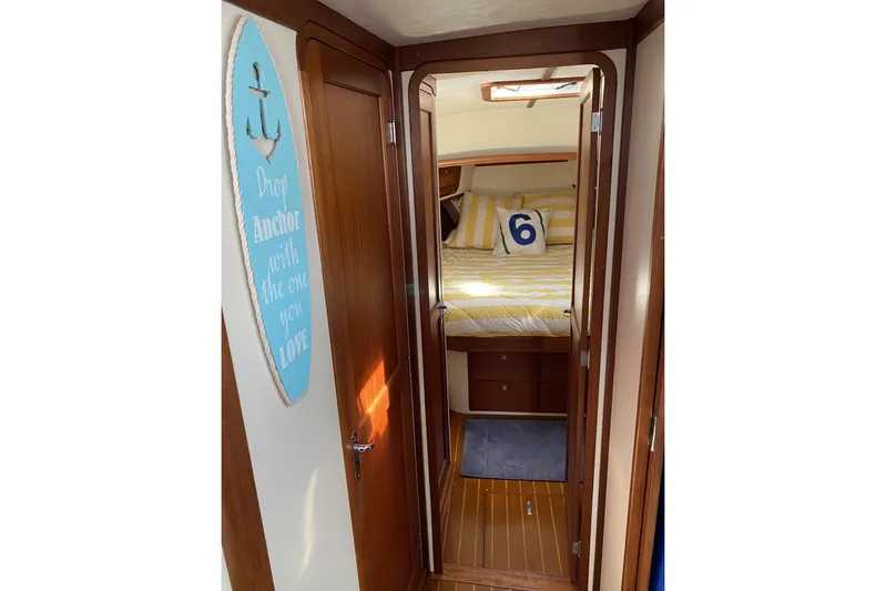 Escapade Yacht Photos Pics 1999 Legacy Yachts 40 Sedan interior with cozy bedroom and nautical decor.