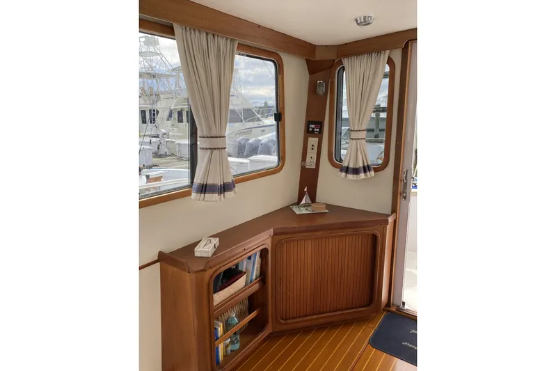 Escapade Yacht Photos Pics Interior of 1999 Legacy Yachts 40 Sedan with wooden cabinetry and nautical decor.