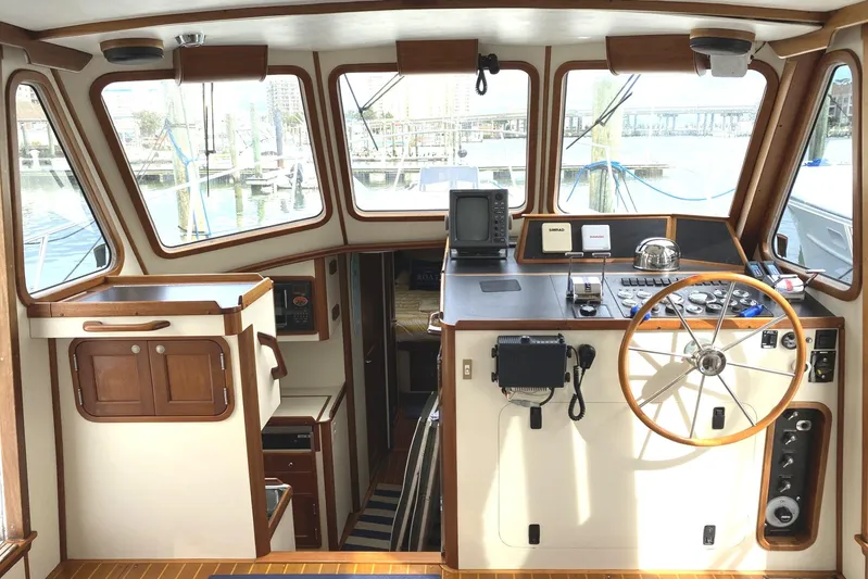 Escapade Yacht Photos Pics 1999 Legacy Yachts 40 Sedan interior helm with wooden accents and navigation equipment.
