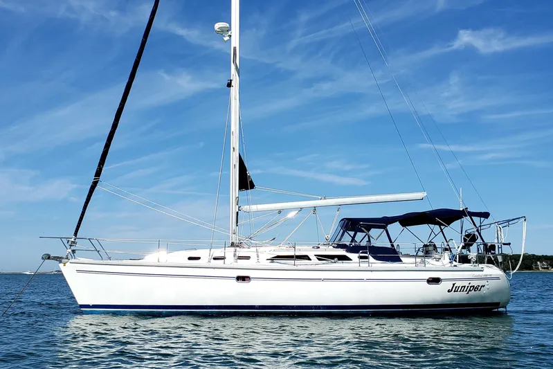 "juniper" Yacht Photos Pics 2006 Catalina 400 MkII sailboat on calm water under a clear blue sky.
