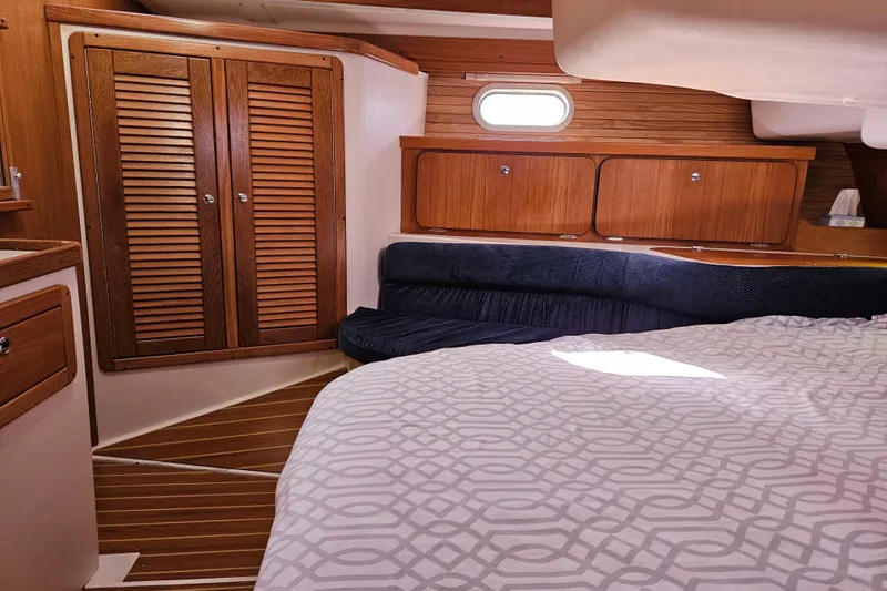 "juniper" Yacht Photos Pics Interior of 2006 Catalina 400 MkII sailboat with wood cabinetry and cozy sleeping area.