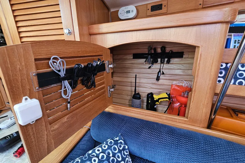 "juniper" Yacht Photos Pics Wooden cabinet in a 2006 Catalina 400 MkII yacht, storing tools and cables.