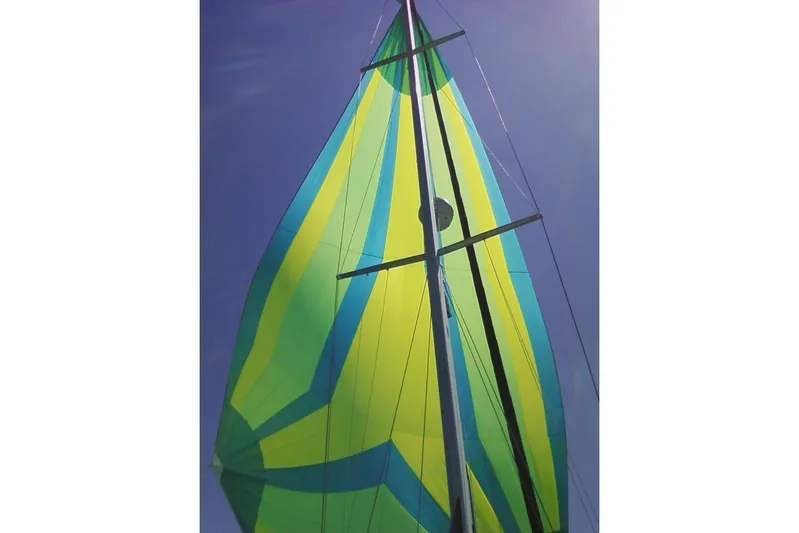 "juniper" Yacht Photos Pics Colorful sail of 2006 Catalina 400 MkII against clear blue sky.