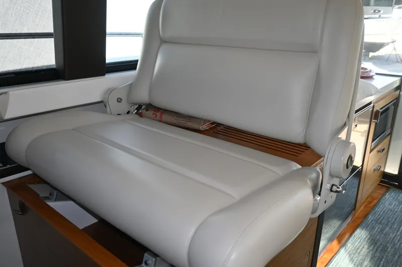 Present Tense Yacht Photos Pics Luxurious white leather electrically adjustable helm seat in 2017 Tiara 44 Coupe yacht interior.
