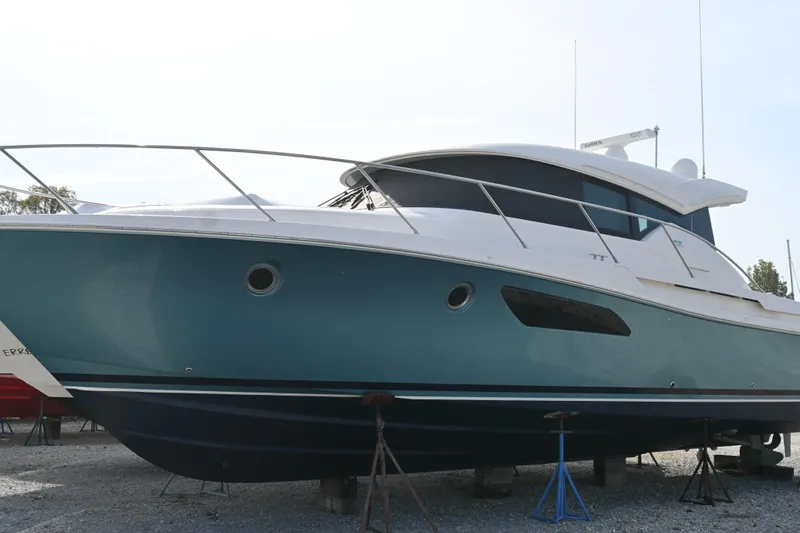 Present Tense Yacht Photos Pics 2017 Tiara 44 Coupe yacht on stands, side view, outdoors.