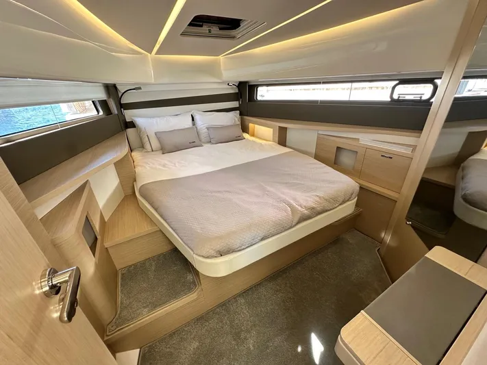  Yacht Photos Pics Luxurious cabin interior of 2025 Jeanneau DB/37 OB yacht with modern design and cozy bedding.
