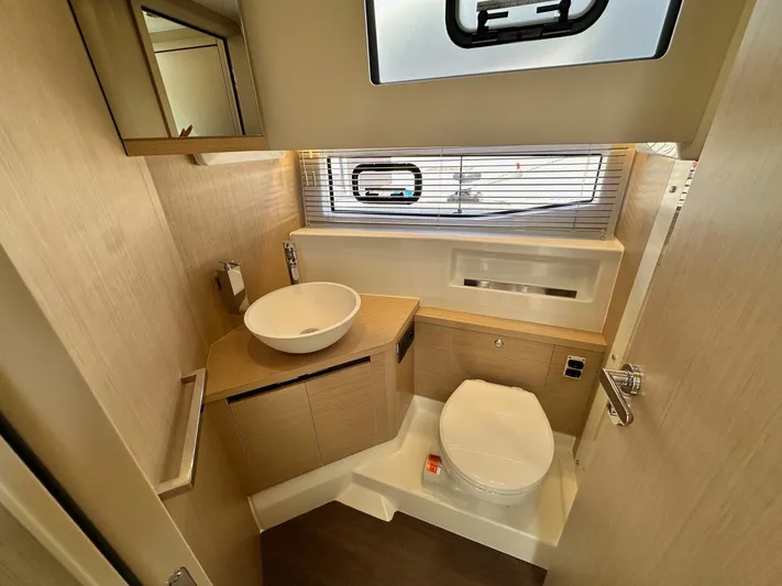  Yacht Photos Pics Modern bathroom interior of 2025 Jeanneau DB/37 OB yacht with sleek fixtures.