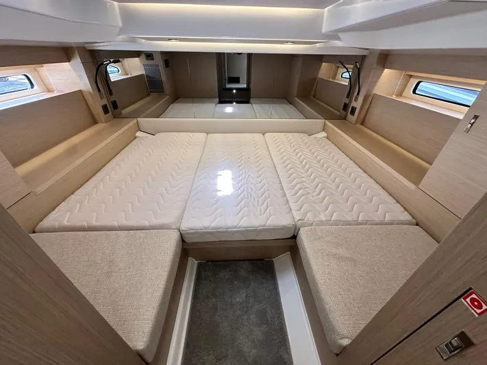  Yacht Photos Pics Luxurious cabin interior of 2025 Jeanneau DB/37 OB with spacious bedding and modern design.