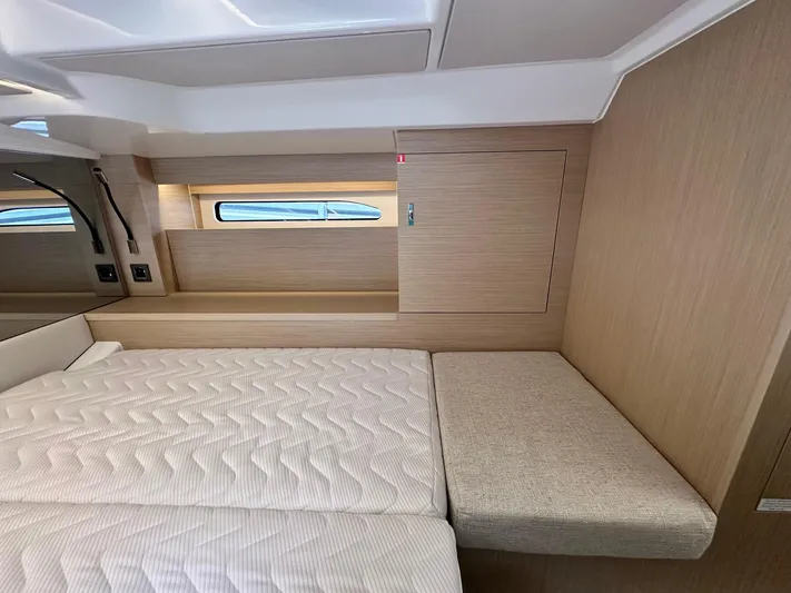  Yacht Photos Pics 2025 Jeanneau DB/37 OB cabin interior with modern wood finish and comfortable bedding.