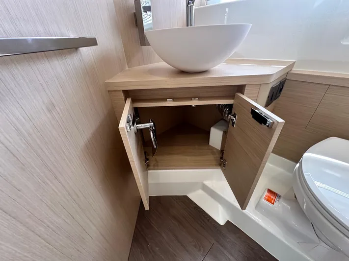  Yacht Photos Pics 2025 Jeanneau DB/37 OB bathroom with modern sink, open cabinet, and toilet.
