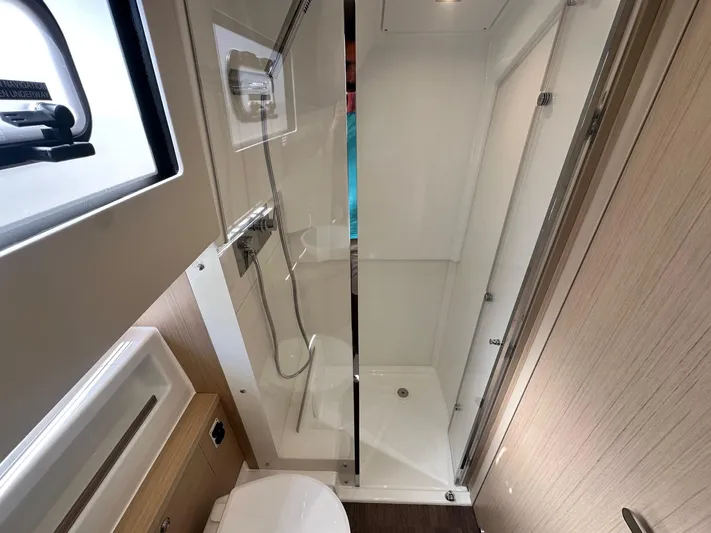  Yacht Photos Pics 2025 Jeanneau DB/37 OB yacht bathroom with shower, sink, and modern fixtures.