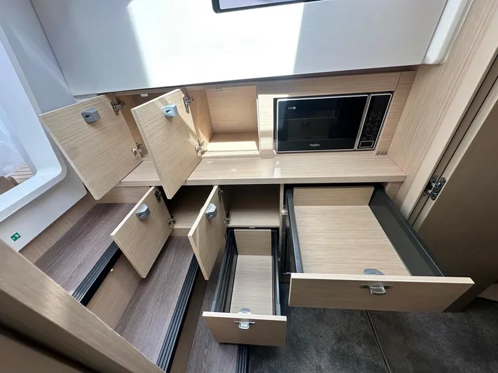  Yacht Photos Pics Modern kitchen cabinetry with open drawers and microwave in Jeanneau DB/37 OB, 2025 model.