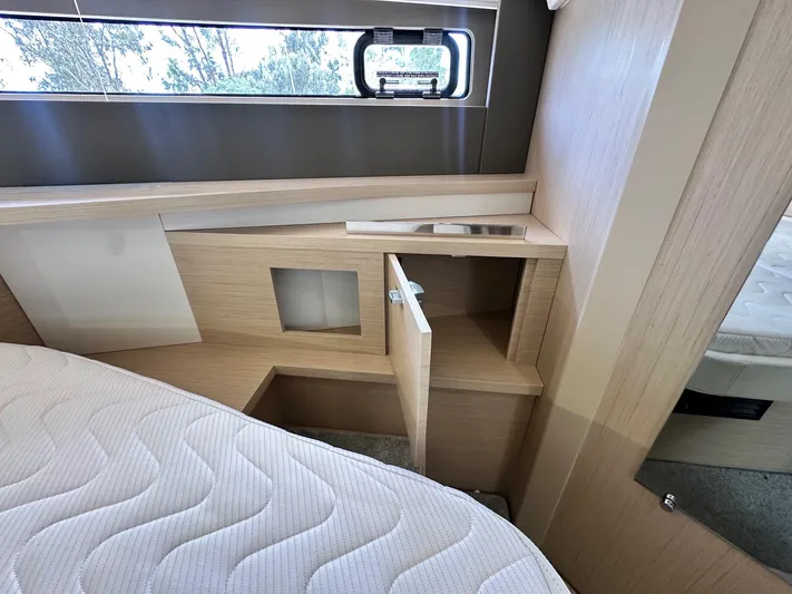  Yacht Photos Pics 2025 Jeanneau DB/37 OB cabin interior with open storage and window view.