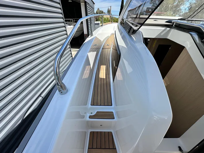  Yacht Photos Pics 2025 Jeanneau DB/37 OB boat deck with sleek design and wood finish.