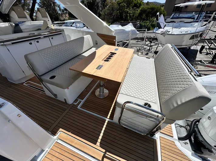  Yacht Photos Pics 2025 Jeanneau DB/37 OB boat interior with elegant seating and wooden table.