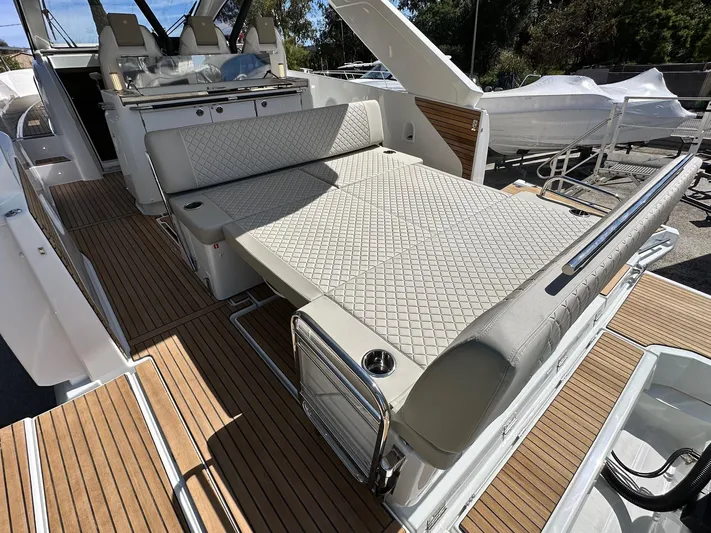  Yacht Photos Pics 2025 Jeanneau DB/37 OB boat interior with luxurious seating and wooden flooring.