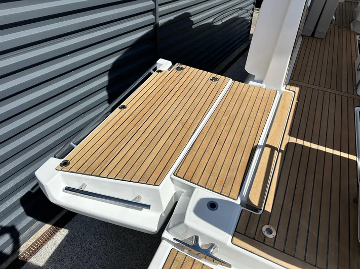  Yacht Photos Pics 2025 Jeanneau DB/37 OB boat deck with wood finish and sleek design.