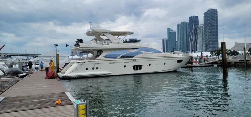Thinks It's His Too Yacht Photos Pics 2008 Azimut Flybridge yacht docked at a marina with city skyline in the background.