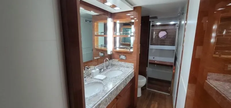 Thinks It's His Too Yacht Photos Pics Luxurious bathroom in a 2008 Azimut Flybridge yacht with double sinks and wooden accents.