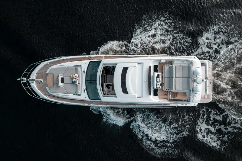  Yacht Photos Pics Aerial view of a 2019 Prestige 590 S yacht cruising on dark waters.