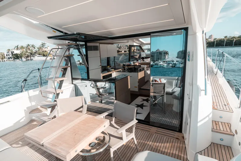  Yacht Photos Pics Prestige 590 S 2019 yacht interior with dining area and kitchen, docked by the water.