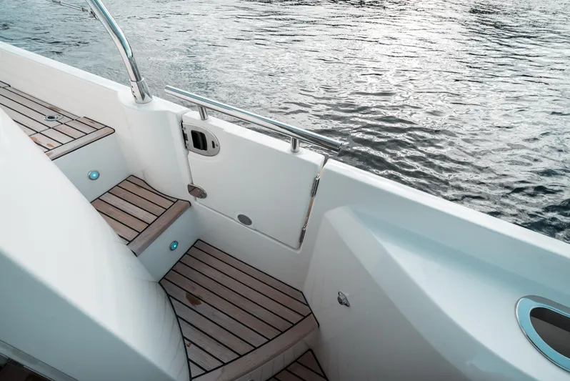  Yacht Photos Pics Prestige 590 S 2019 yacht deck with wooden steps and water view.