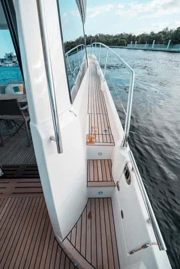  Yacht Photos Pics Side deck view of 2019 Prestige 590 S yacht cruising on water.