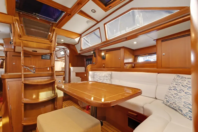 Avventura Yacht Photos Pics Luxurious interior of 2009 Hylas 46 yacht with wooden finishes and cozy seating.