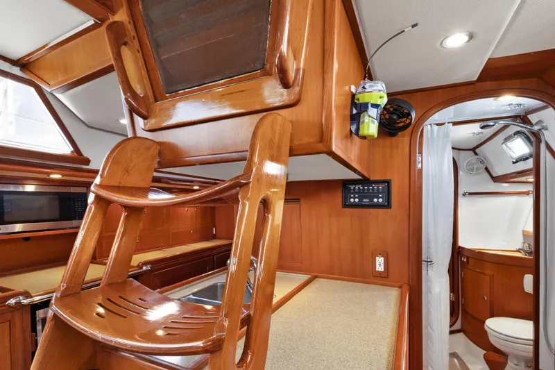 Avventura Yacht Photos Pics Interior of a 2009 Hylas 46 yacht featuring a wooden finish and compact bathroom.