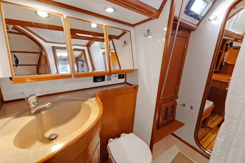 Avventura Yacht Photos Pics Luxurious 2009 Hylas 46 yacht bathroom with wooden accents and modern fixtures.