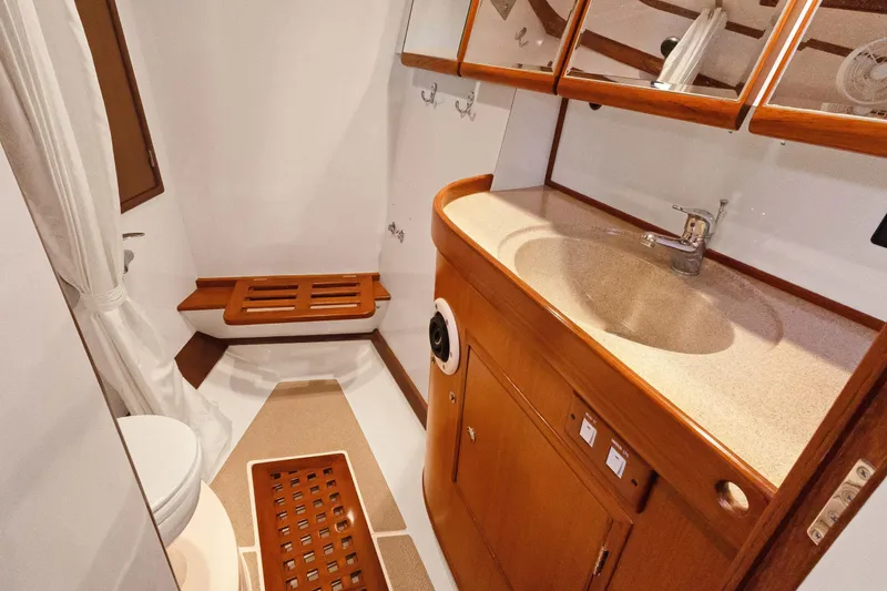 Avventura Yacht Photos Pics Luxurious bathroom in 2009 Hylas 46 yacht with wooden cabinetry and modern fixtures.