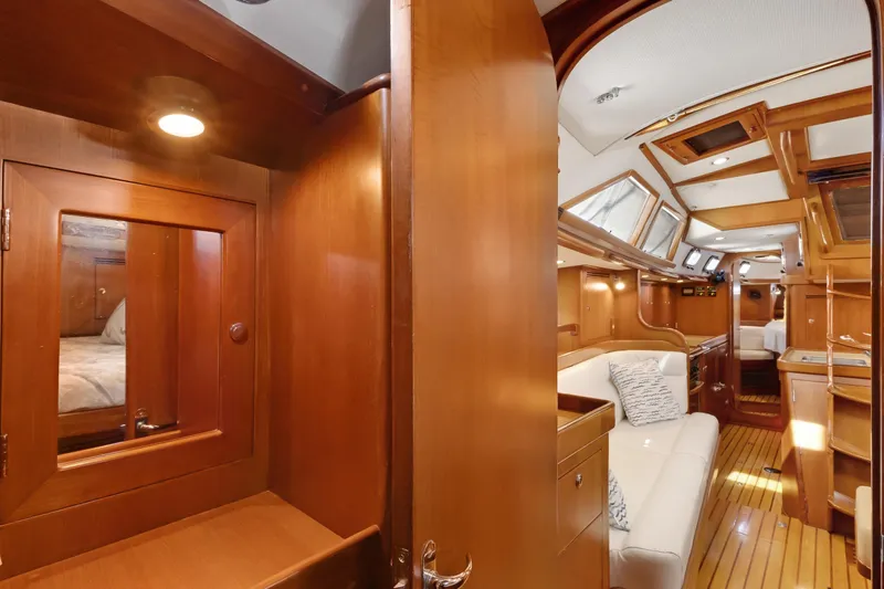 Avventura Yacht Photos Pics Luxurious interior of a 2009 Hylas 46 yacht with wood finishes and cozy seating.