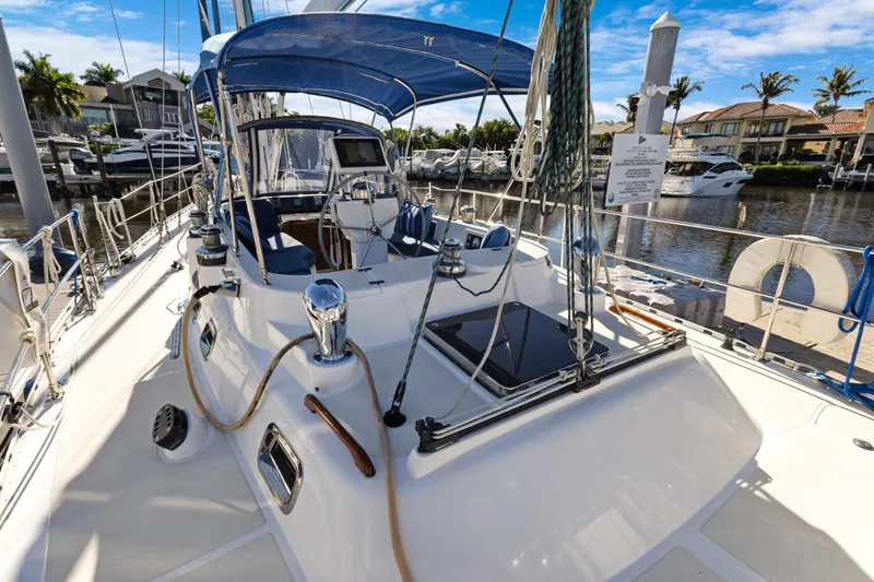 Avventura Yacht Photos Pics 2009 Hylas 46 sailboat docked, featuring a spacious deck and blue canopy.