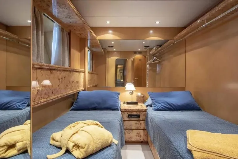  Yacht Photos Pics Luxurious twin cabin on Codecasa Falco 24 yacht, featuring elegant wood finishes and cozy bedding.