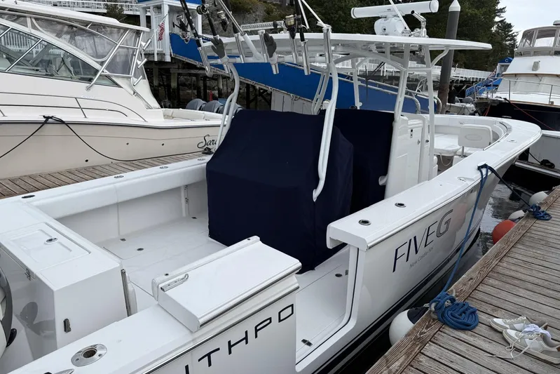  Yacht Photos Pics 2018 Southport 33 FE boat docked, featuring sleek design and fishing equipment.