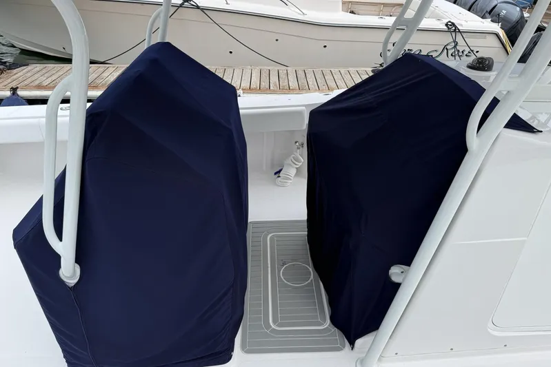  Yacht Photos Pics 2018 Southport 33 FE boat with covered seats, docked at a marina.