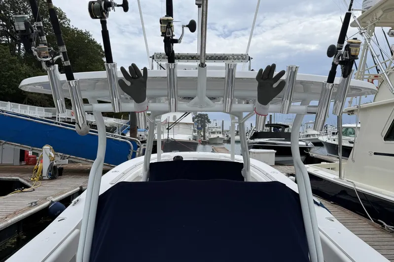  Yacht Photos Pics 2018 Southport 33 FE boat with fishing rods and gloves at a marina.