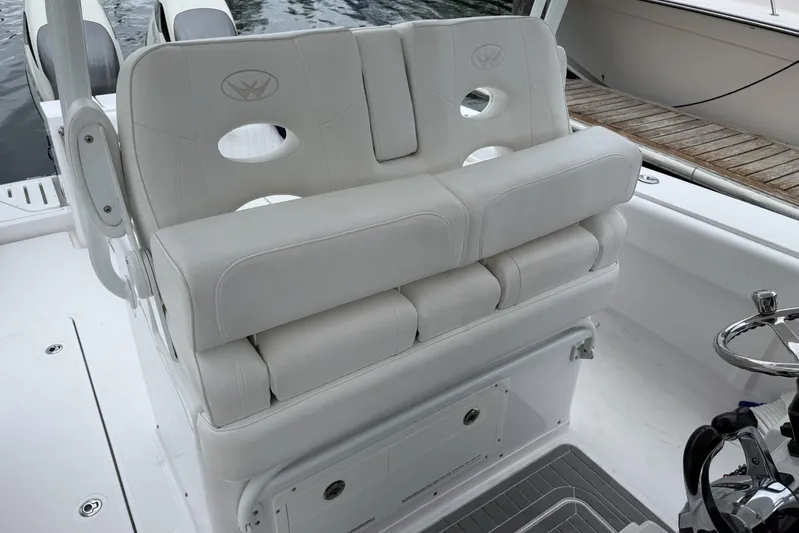  Yacht Photos Pics Luxurious seating on 2018 Southport 33 FE boat, featuring plush white upholstery.
