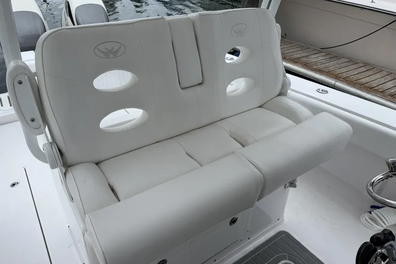 Yacht Photos Pics 2018 Southport 33 FE boat seat with white cushioned design and circular cutouts.
