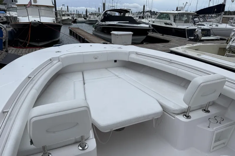  Yacht Photos Pics 2018 Southport 33 FE boat with white seating, docked at a marina.