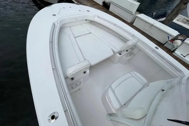  Yacht Photos Pics 2018 Southport 33 FE boat interior with white seating and deck, docked by the water.