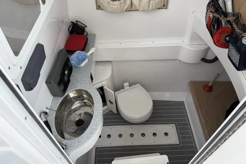  Yacht Photos Pics 2018 Southport 33 FE boat bathroom with sink, toilet, and storage.