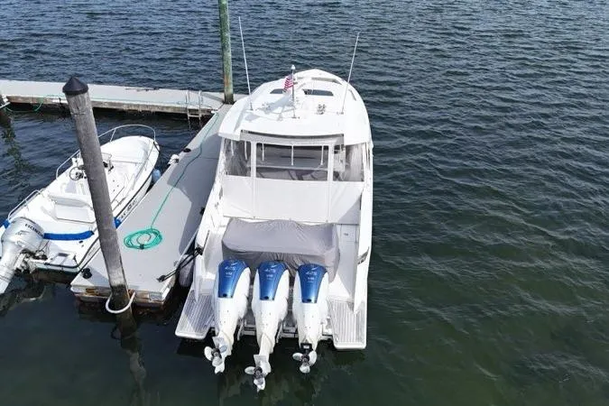 Carry On Yacht Photos Pics 2021 Tiara Sport 43 LS yacht docked with triple outboard engines.
